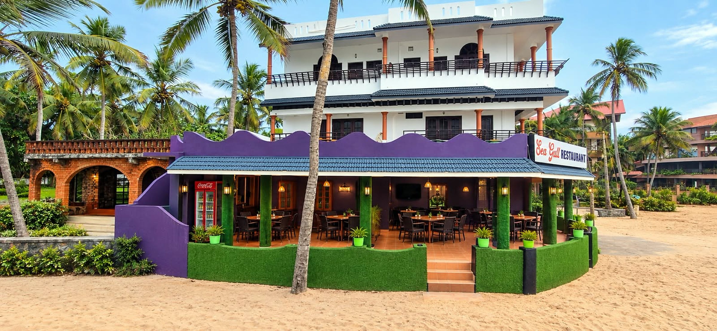 The Sea Gull Restaurant, open-sided, on the sand under coconut palms